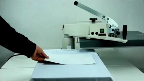 Operator Loads Transfer Sheet onto Heat Press Surface Stock Footage 321180651