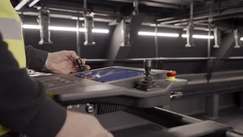 Operator Lowers Hoist Chains With Joystick on Control Panel with Touchscreen. Stock Footage 302761143
