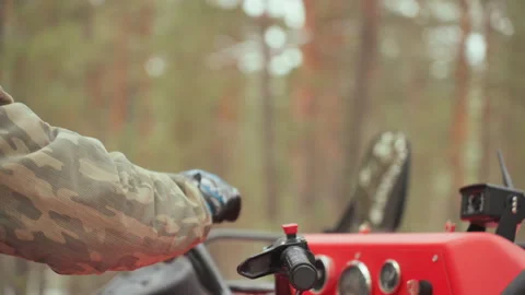 Operator maneuvers ATV through winter. Caucasian rider expertly manages offroad Stock Footage 332050891