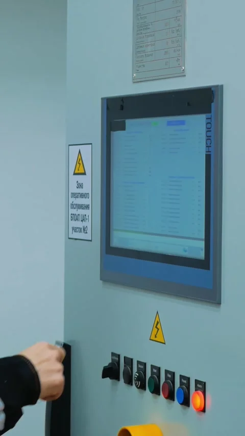 Operator manually adjusts equipment parameters via control panel, using Stock Footage 287538715