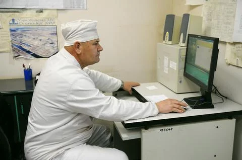 Operator observing condition of the reactor looking at the monitor of compu.. Stock Photos