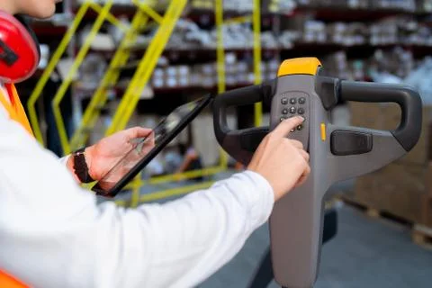 Operator of the pallet loading machine makes the setting Stock Photos