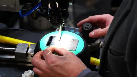 The operator performs laser soldering of metal Stock Footage 232579990