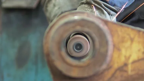 Operator polishing the inside of a shaft with a hand-held power tool in a Stock Footage 171219279