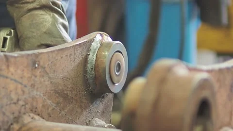 Operator polishing internal axis of part in industrial workshop with an Video stock 197812649