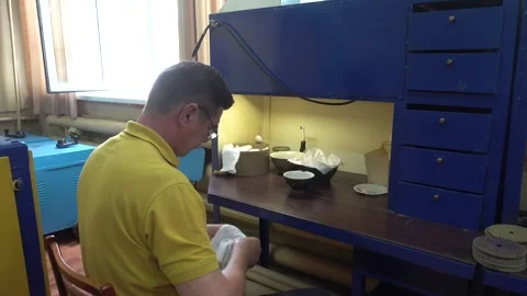 Operator Prepares Dental Prostheses for Ionic-Plasma Deposition with Gold Stock Footage 91666422