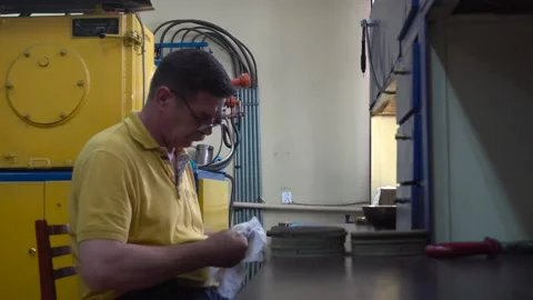 Operator Prepares Dental Prostheses for Ionic-Plasma Deposition with Gold Stock Footage 91666482