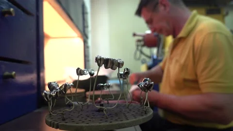 Operator Prepares Dental Prostheses for Ionic-Plasma Deposition with Gold Stock Footage 91666552