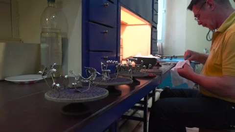 Operator Prepares Dental Prostheses for Ionic-Plasma Deposition with Gold Stock Footage 91666568