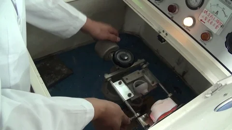 An operator is preparing the centrifugal induction casting machine. Dental lab. Stock Footage 82580705