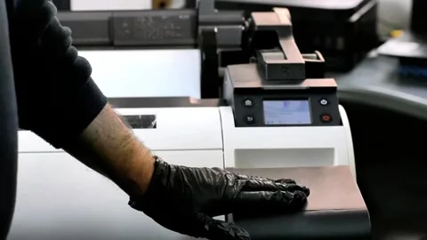 Operator Preps Plotter for Print Job in Production Setting 스톡 동영상 320991334