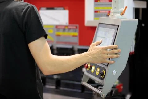 Operator programming CNC press brake machine Stock Photos