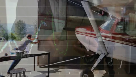 Operator pushing hangar open to tarmac, pilot checking plane controls with live Stock Footage 308100534