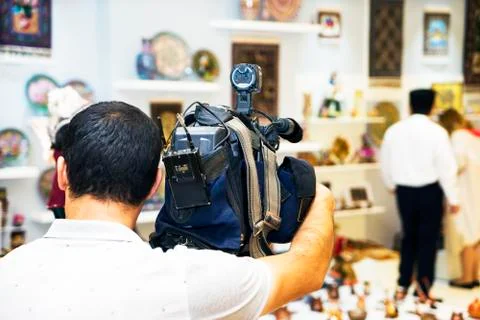 The operator removes the video camera guests at the exhibition Stock Photos