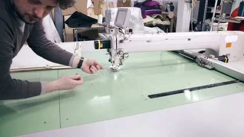 Operator is serving Computerized Automatic Quilting Machine Video stock 88543940
