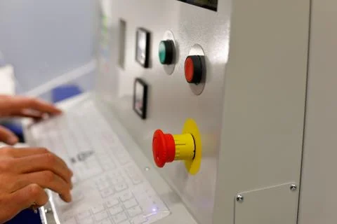 Operator sets the parameters of CAM equipment Stock Photos