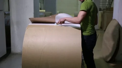 The operator sets up a roll of newsprint in the printing press. Print the newspa Stock-Footage 75451909