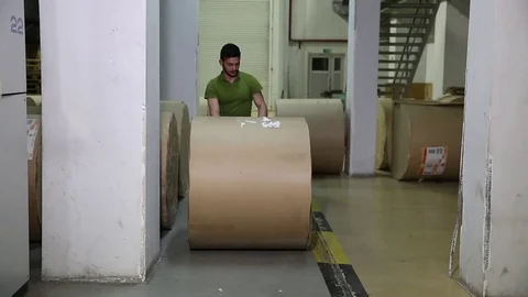 The operator sets up a roll of newsprint in the printing press. Print the newspa Stock Footage 75451920