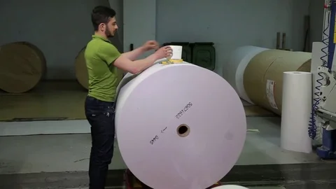 The operator sets up a roll of newsprint in the printing press. Print the newspa Stock Footage 75452018