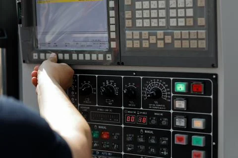 Operator sets up the work of the CNC machine Stock Photos