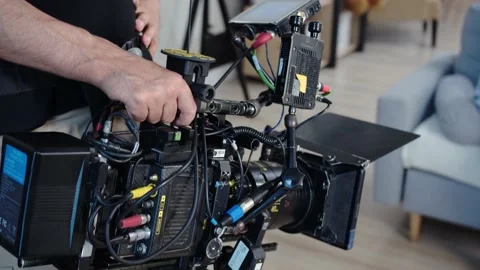 The operator shoots on a professional camera holding it in his hands on weight Stock Footage 195120441