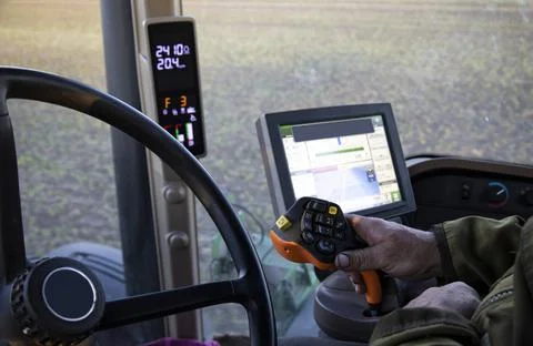 The operator of the special tractor processes agricultural fields. Close-up of Stock Photos