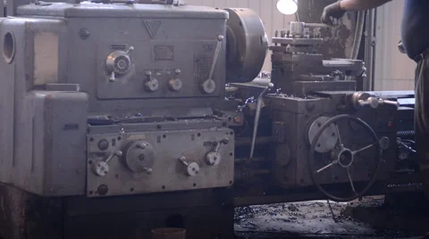 The operator is standing at the milling machine and controls the cut from the Stock Footage 57688572