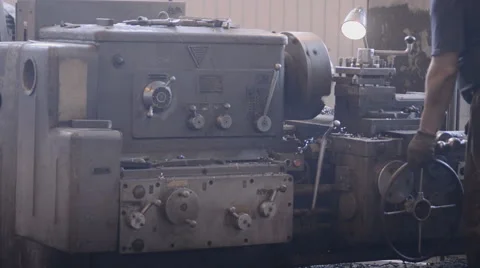 The operator is standing at the milling machine and lathe and hand controls and Stock Footage 57688644