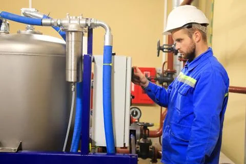 Operator of substation controls parameters electrical equipment. Stock Photos