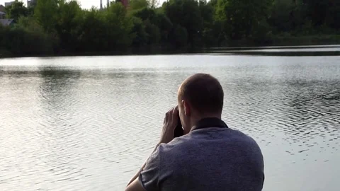 The operator takes photos of nature on camera Stock Footage 75963965