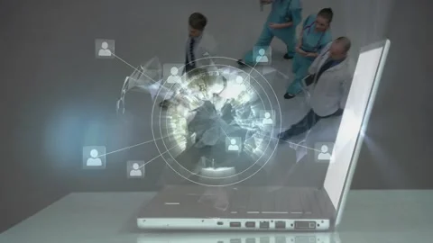 Operator tapping keyboard on silver laptop activating globe linking medical 库存影片 334115191