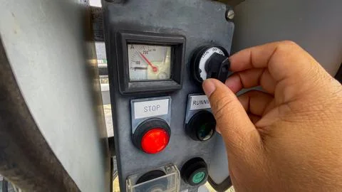 Operator technician hand turning the selector switch on a local control swi.. Stock Photos