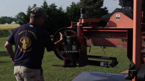 Operator tightens blade on portable sawmill Stock Footage 40472224