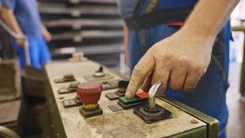 Operator Turning Knobs on Automatic Saw Control Panel Stock Footage 337190098