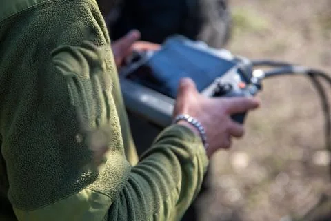 Operator using drone remote controller with connected cables Stock Photos