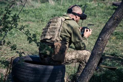 Operator using drone remote controller with connected cables Фото