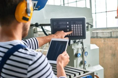 Operator Using Modern Machine Units at Plant Stock Photos