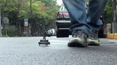 An operator is using a water leak detector on a road of Taipei city, Taiwan. Stock Footage 69268779