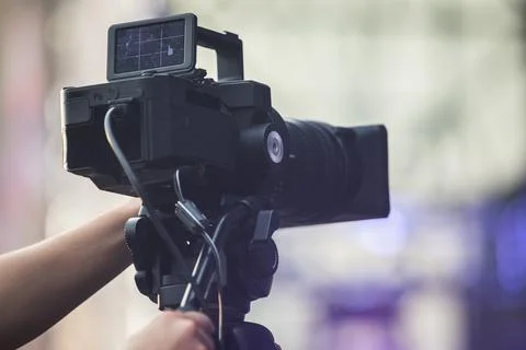 Operator with a video camera records a reporting event at an open public event Stock Photos