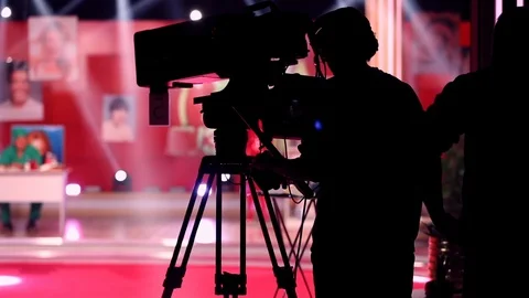 Operator with videocamera shooting, operator with videocamera and film crew in Stock Footage 96242056