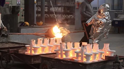 Operator wearing silver fireproof suit pouring liquid iron  mold safety first Video stock 252116437