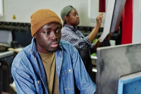 Operator working on computer machine in plant Stock Photos