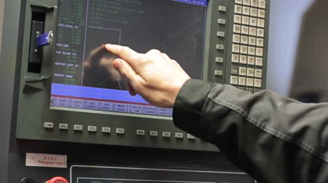 Operator working with control panel of CNC machining centerchanging numbers 스톡 동영상 60235177