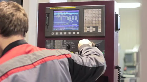 Operator working with control panel of CNC machining centerchanging numbers 스톡 동영상 60235420
