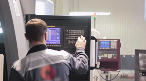 Operator working with control panel of CNC machining centerchanging numbers 스톡 동영상 60799188