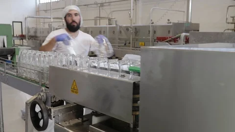 Operator working in Tomato Sauce Factory. Moving empty bottles Stock Footage 98598098