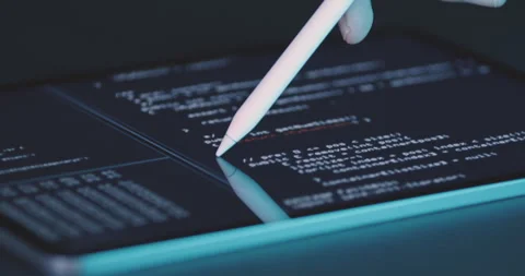 Operator works on tablet screen on program code with stylus Stock Footage 248206452