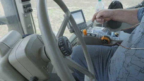 Operator's cab of a modern tractor with trailer equipment in the process of till Stock Footage 131765287
