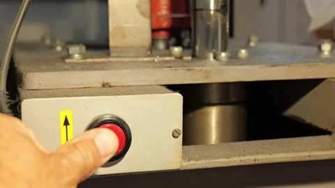 Operator's hand pushing red button on machine control panel 動画素材 338188681