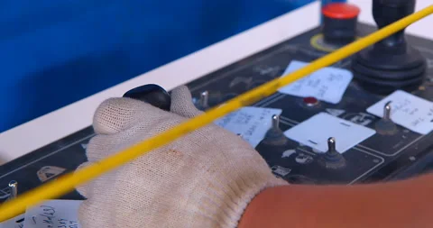 Operator's hands in gloves, using buttons and joysticks, operate the liftingt Stock Footage 147635215